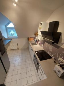 an overhead view of a kitchen with white appliances at Reinfeld Zentral in Reinfeld