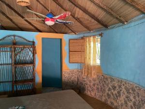 a room with a ceiling fan and a window at MANGO LODGE in Bubaque +26 photos