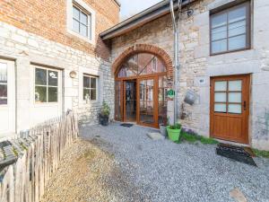 an entrance to a brick building with a wooden door at Charming holiday home in Durbuy with garden in Durbuy