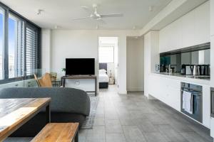a living room with a couch and a tv at EIGHT TWO NINE TWO IV: BONDI BEACH in Sydney