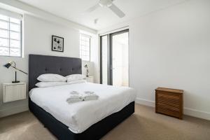 a bedroom with a large bed with two towels on it at EIGHT TWO NINE TWO IV: BONDI BEACH in Sydney