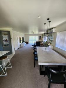 a dining room with a table and chairs at The Sanctuary Papamoa Beach in Papamoa