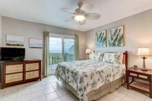 a bedroom with a bed and a flat screen tv at 95066 Sandpiper Loop in Fernandina Beach
