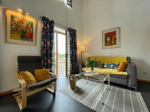 a living room with a couch and a chair at Gîte Polignac, 3 pièces, 4 personnes - FR-1-582-58 in Polignac