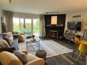 a living room with a couch and a fireplace at Newly Updated Modern, Spacious, and Cozy Condo- Right on the Lake! in Lake Geneva