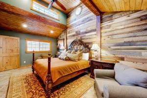 a bedroom with a bed and a wooden wall at Flagstaff Fantasy - Entire Property in Flagstaff