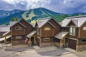 a large house with a mountain in the background at Antler Way at Lakota,,,, townhouse in Winter Park