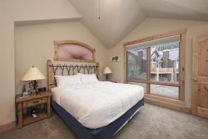 a bedroom with a large bed and a window at Antler Way at Lakota,,,, townhouse in Winter Park