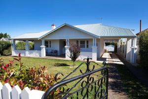 a white house with a fence in front of it at THE WHITE HOUSE luxury villa embedded in history in Penola +8 photos