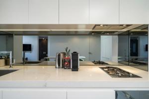 a kitchen with a counter top with a stove in it at EIGHT TWO NINE TWO V: BONDI BEACH in Sydney