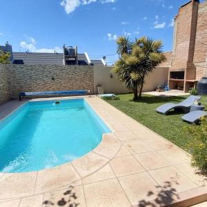 a swimming pool in the backyard of a house at Casa Girasoles in Centenario