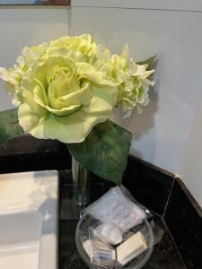 a vase filled with yellow flowers on a counter at Blue Apartment Copacabana in Rio de Janeiro