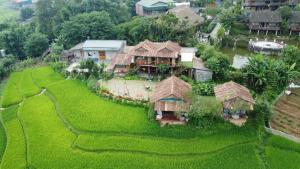 an aerial view of a house on a rice field at May Homestay in Lao Cai