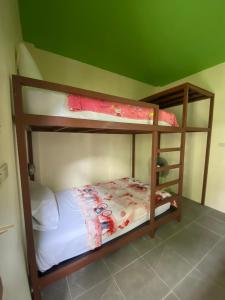 Nadapa Resort في كو تاو: سريرين بطابقين في غرفة ذات سقف أخضر
