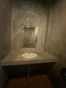 a bathroom with a sink and a mirror at Nadapa Resort in Koh Tao