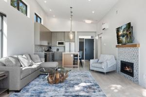 a living room with a couch and a fireplace at Beachfront Luxury Suite #21 at THE BEACH HOUSE in Campbell River