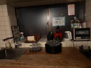 a kitchen counter with a sink and glasses on it at Numazu Ikyuuan 沼津一休庵 in Numazu
