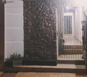 a front door of a house with a stone wall at Cantinho da Rota ll in São Roque