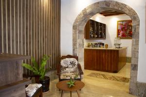 a living room with a chair and a table at Llamita Hotel-Huancayo in Huancayo