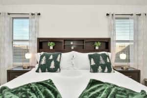 a bedroom with a white bed with green pillows at Exquisite 3 Bedroom Home in Katy in Katy