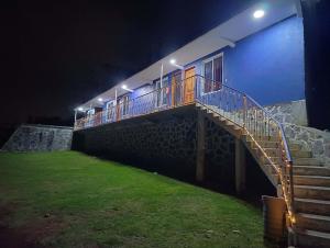 a blue building with a staircase on it at night at Hospedaje Escorza in San Miguel Regla