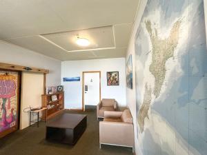 a waiting room with a large mural on the wall at Hippo Lodge Backpackers in Queenstown