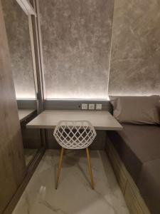 a small desk in a small room with a bed at Mashley Room Prestige Apartment SKY HOUSE BSD in Tjilandak