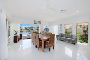 a living room with a table and a couch at The Noosa Haven Luxe Waterfront Home in Noosaville