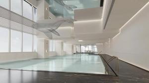 a large room with a swimming pool in a building at Yutai Hotel Apartment in Shenzhen