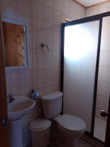 a bathroom with a toilet and a sink at Cabañas Marlen in Limache