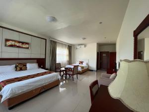 a hotel room with a bed and a table and chairs at Meida Hotel in Nuku‘alofa