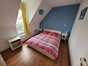 - une chambre dotée d'un lit avec des draps roses et rayés dans l'établissement Villa Wimereux, 4 pièces, 6 personnes - FR-1-675-33, à Wimereux