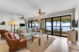 a living room with a couch and a table at Poipu Shores 403A in Koloa