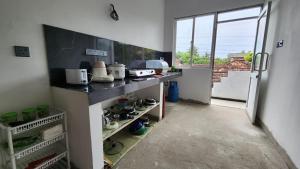 a kitchen with a counter and a door to a balcony at E Seven House in Dickwella +25 photos