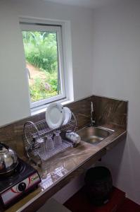 a kitchen counter with a sink and a window at Olive Launch in Weligama