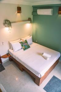 a bed in a room with a large white mattress at Gili Divers Hotel in Gili Trawangan