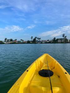 a yellow kayak in the water on a lake at Rum punch lodge in Corozal