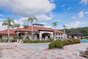 a resort with a swimming pool and palm trees at Pool-side Grill, Private Movie, 5 Ensuite-Bdr Villa in Kissimmee