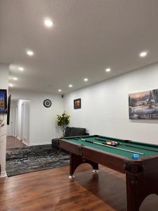 a living room with a pool table and a couch at DARON HOMES in Brampton