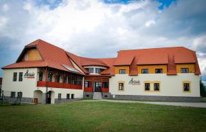 a large building with a red roof at Amadé Pension in Siculeni