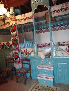 a room with two bunk beds and chairs at ARCHONTIKO Traditional House 1850 in Olympos