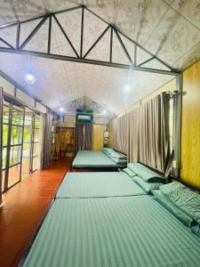 a room with three beds in it at suri mũi né homestay in Phan Thiet