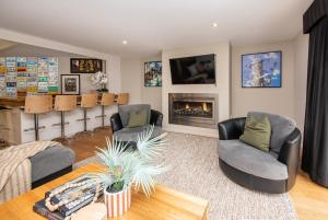 a living room with two chairs and a fireplace at Yera Lodge Coastal Homestead in Rye Spa/Tennis Crt in Rye