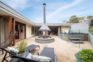 an outdoor patio with a fire pit and a grill at Yera Lodge Coastal Homestead in Rye Spa/Tennis Crt in Rye