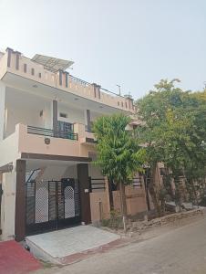 a large building with a balcony on a street at Vanita home stay in Udaipur