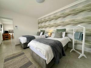 a bedroom with two beds and a wall mural at AuobCorner in Walvis Bay