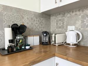a kitchen counter with a toaster and a coffee maker at AuobCorner in Walvis Bay +7 photos