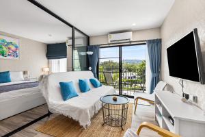 a hotel room with a bed and a tv at Bright Apartment Close to Amazing Beach ! 39 Sqm in Nai Yang Beach