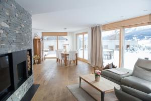 a living room with a couch and a fireplace at Valmala holiday flat for 5 people and a family dog with fenced garden in Lenz