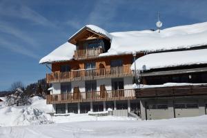 a building with snow on top of it at Gasthof Hirschen in Sibratsgfäll